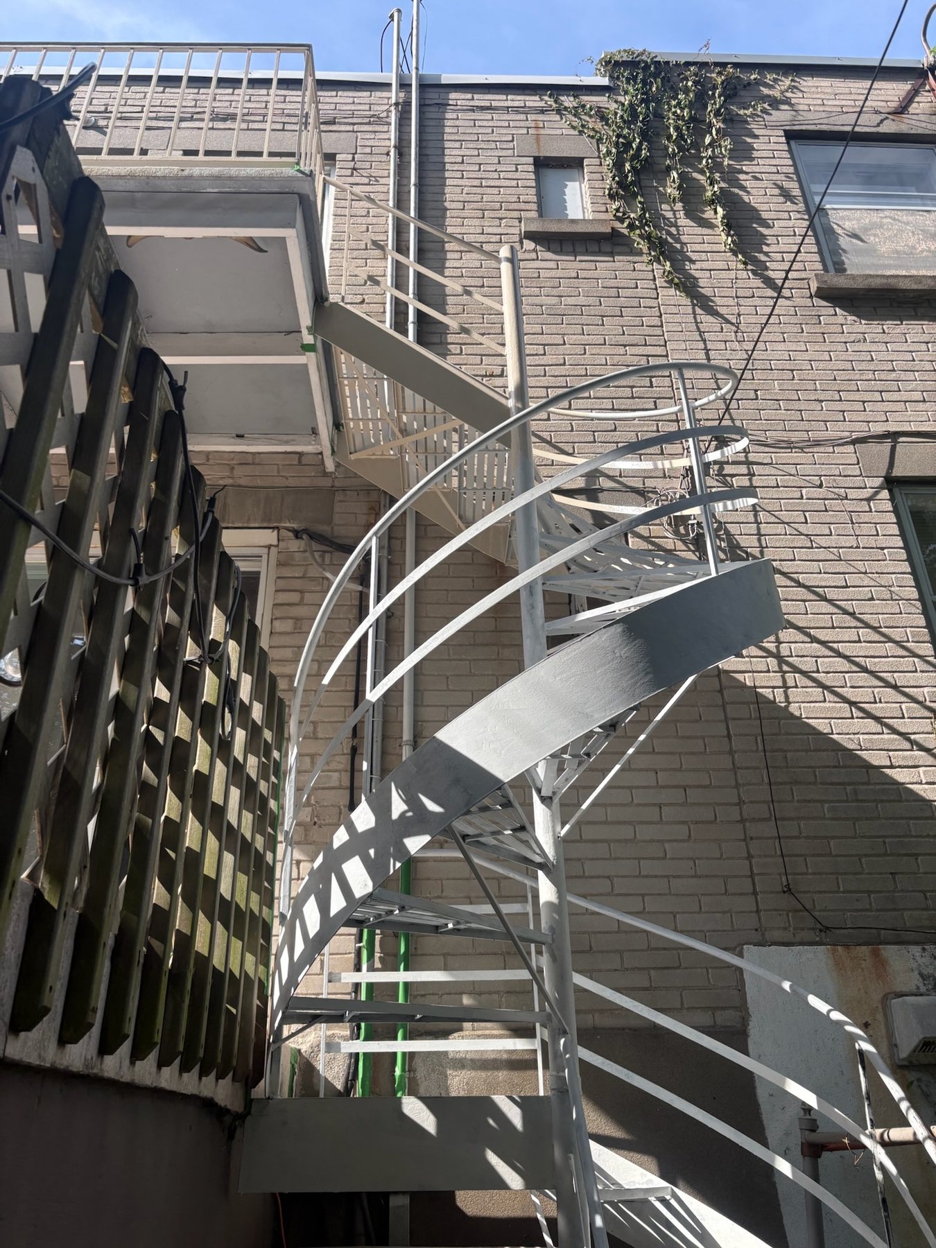 Escalier en colimaçon en fer forgé repeint en gris